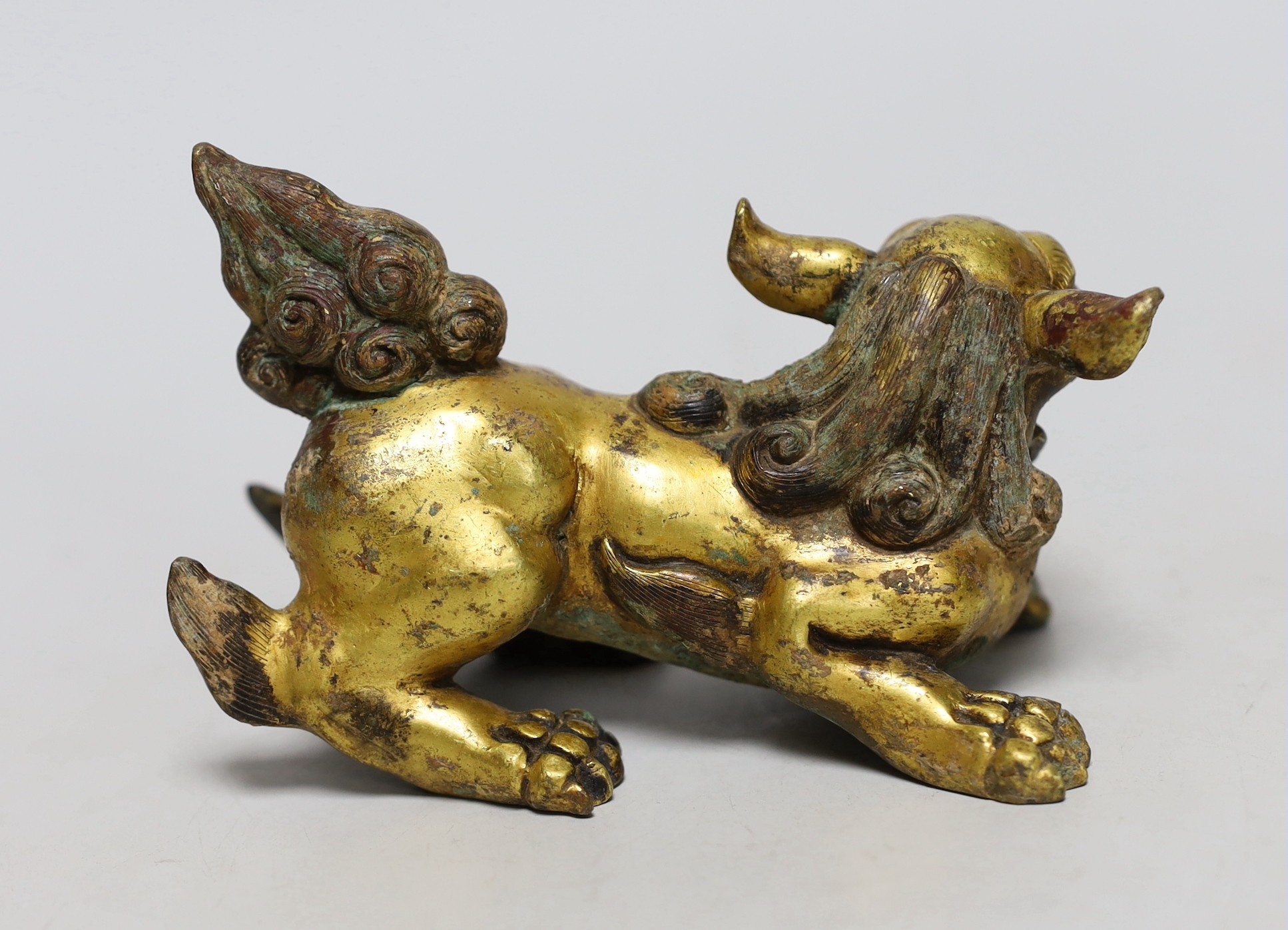 A Chinese gilt bronze figure of a lion dog, Han or later, 13cm wide